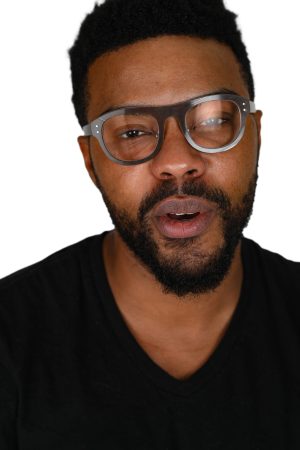 Man with glasses and beard speaking.