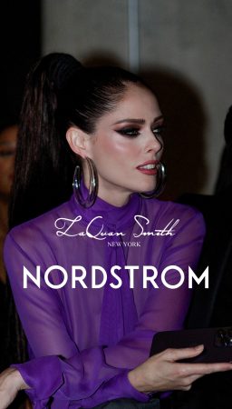 Model in purple outfit with dramatic makeup for Nordstrom ad.