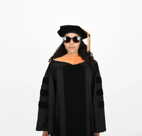 Graduate in academic regalia with sunglasses and a beret.