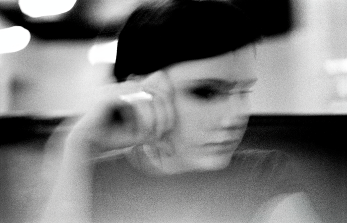 Blurred black and white portrait of a person with a contemplative expression.